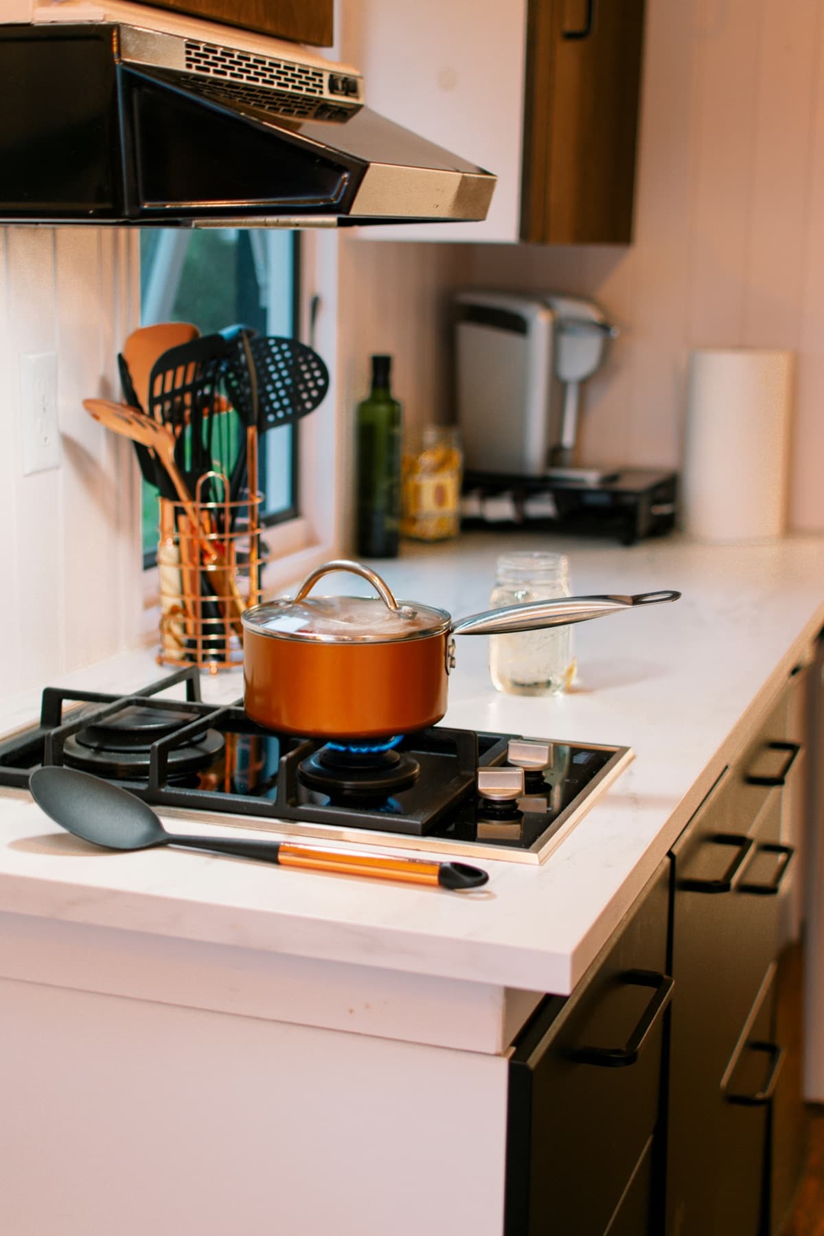 Pot cooking on a gas hob in a modern kitchen